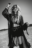 Windswept AI fashion editorial in a desert setting, featuring a woman with long hair, chains, and layered black clothing
