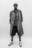 Confident AI-generated portrait of a model in oversized Bareen coat, striped shirt, and chunky sneakers, standing against a plain white backdrop