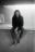 AI-crafted image of a long-haired man sitting on a skate pool edge, wearing Vans and staring directly at the viewer