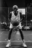 Black and white AI-generated portrait of an older basketball player gripping a ball on a dimly lit street court, wearing Nike gear — full of presence, grit, and determination